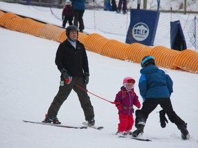 Charlotte Neumann, who will soon turn three, is followed by her father Allan, as she learns how to ski from an instructor at Boler Mountain. (JONATHAN JUHA, The London Free Press)