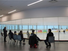 Parents watch their kids play hockey at the Bostwick Community Centre, while sitting on some chairs provided by staff at the facility. After weeks of delays, the city is expected to install the ice pad seating in early 2019. (JONATHAN JUHA, The London Free Press)
