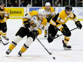 Sarnia Sting's Jamieson Rees (39) tries to outrace Kingston Frontenacs' Emmett Gordon (8) in the first period at Progressive Auto Sales Arena in Sarnia, Ont., on Saturday, Dec. 8, 2018. (Mark Malone/Chatham Daily News/Postmedia Network)