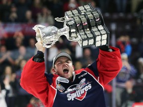 Michael DiPietro of the Windsor Spitfires lifts the Memorial Cup trophy on May 28, 2017, at the WFCU Centre in Windsor, ON after defeating the Erie Otters.