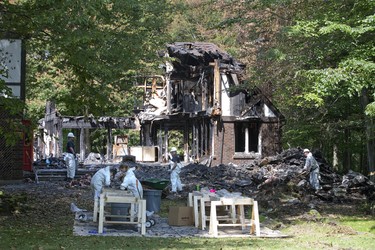 Employees of Belfor Property Restoration search for valuables by sifting through the remains of a house destroyed by fire at 4 Aspen Place in Lambeth. Derek Ruttan/The London Free Press/Postmedia Network