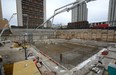 Workers pour over 1300 cubic meters of concrete forming a raft slab foundation for a new 24-floor residential tower on York Street. (File photo)