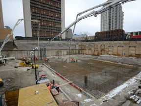 Workers pour over 1300 cubic meters of concrete forming a raft slab foundation for a new 24-floor residential tower on York Street. (File photo)