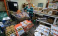 Volunteer Susan Glen helps sort food at the London Food Bank. (File photo)