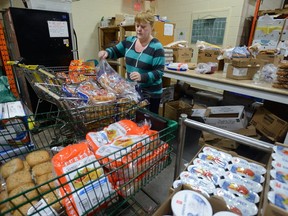 Volunteer Susan Glen helps sort food at the London Food Bank. (File photo)