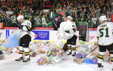 Knights forward Cole Tymkin, Billy Moskal and Matthew Timms start to collect teddy bears after Knights' defenceman Adam Boqvist scored late in the first period of their game unleashing the teddy bear toss during their game against the Sarnia Sting at Budweiser Gardens on Sunday December 2, 2018. 
Mike Hensen/The London Free Press/Postmedia Network