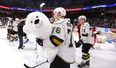 Knights forward Billy Moskal collects a large polar bear teddy bear after Knights' defenceman Adam Boqvist scored late in the first period of their game unleashing the teddy bear toss during their game against the Sarnia Sting at Budweiser Gardens on Sunday December 2, 2018. 
Mike Hensen/The London Free Press/Postmedia Network