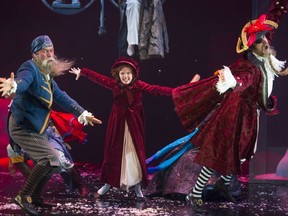 Riley DeLuca playing the youngest version of Scrooge in the the Grand Theatre's production of A Christmas Carol, has a fantasy battle with pirates (played by Sean Arbuckle and Aidan deSalaiz) from one of the books she is reading. (Mike Hensen/The London Free Press)