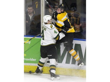 London Knights defenceman William Lochead slams Kington Frontenacs forward Cameron Hough into the glass during the first period of their OHL game at Budweiser Gardens in London on Friday night. The Knights won 8-1. Derek Ruttan/The London Free Press/Postmedia Network