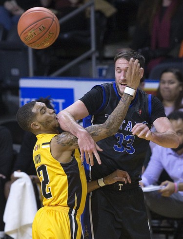 London Lightning  player Xavier Moon gets a taste of Derek Hall's elbow during their NBL basketball game at Budweiser Gardens in London, Ont. on Sunday December 9, 2018. Hall's Kitchener-Waterloo Titans defeated the home team 123-97. Derek Ruttan/The London Free Press/Postmedia Network