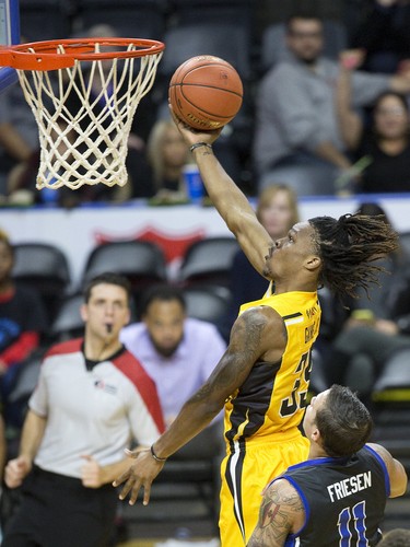 London Lightning  player  AJ Gaines lays up a two points while being covered by the Joel Friesen of the Kitchener-Waterloo Titans at Budweiser Gardens in London, Ont. on Sunday December 9, 2018.  Derek Ruttan/The London Free Press/Postmedia Network