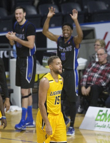 Garrett Williamson of the London Lightning is unimpressed as  Kitchener-Waterloo Titans players  Derek Hall (left)  and Ed Horton celebrate from the bench after taking a 10 point lead in the fourth quarter at Budweiser Gardens in London, Ont. on Sunday December 9, 2018.  The visitors won the game 123-97.Derek Ruttan/The London Free Press/Postmedia Network