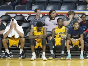 Despondent London Lightning players (L to R Marvell Waithe, Jaylen Babb-Harrison, Kevin Ware and Xavier Moon) sit on the bench near the end of the game agains the Kitchener-Waterloo Titans at Budweiser Gardens in London, Ont. on Sunday December 9, 2018. The Titans won the game 123-97. Derek Ruttan/The London Free Press/Postmedia Network