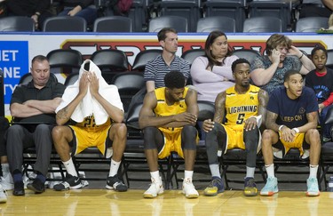 Despondent London Lightning players (L to R Marvell Waithe, Jaylen Babb-Harrison, Kevin Ware and Xavier Moon) sit on the bench near the end of the game agains the Kitchener-Waterloo Titans at Budweiser Gardens in London, Ont. on Sunday December 9, 2018. The Titans won the game 123-97. Derek Ruttan/The London Free Press/Postmedia Network