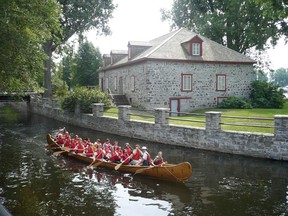 A Rabaska canoe passes the Fur Trade Museum by the old Lachine Canal in Lachine. Early Canadiens travelled across much of North America by canoe.