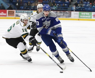Adam Ruzicka, right, of the Sudbury Wolves, attempts to skate around Kevin Hancock, of the London Knights, during OHL action at the Sudbury Community Arena in Sudbury, Ont. on Friday January 18, 2019. John Lappa/Sudbury Star/Postmedia Network