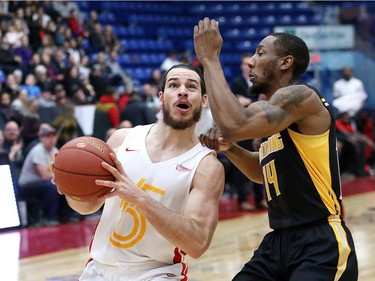 Devin Gilligan, left, of the Sudbury Five, drives to the basket against Marcus Capers, of the London Lightning, during basketball action at the Sudbury Community Arena in Sudbury, Ont. on Friday January 4, 2019. (John Lappa/Postmedia Network)