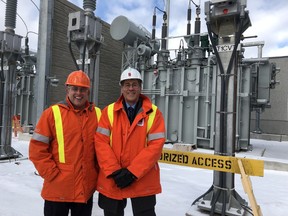 Hydro One's Jason Fitzsimmons, left, and Bill Milroy of London Hydro show off the fully upgraded Nelson Street transformer station. (Jennifer Bieman/The London Free Press)