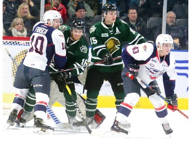 Kevin Hancock and Cole Tymkin of the Knights try to fill the crease in front of Spits goalie Kari Piiroinen while being checked by Jordan Frasca and Louka Henault in the first period of their OHL game at Budweiser Gardens on Friday night. The Knights won 7-0.  (MIKE HENSEN, The London Free Press)