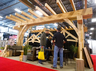 Joe and Raquel Circelli talk to Alex Oke while they were visiting his Okewood Timberworks display at the Lifestyle Homeshow at the Western Fair Agriplex  in London Friday. Oke says the large timbers are always popular on homes, including the huge beams of eastern white pine from northern Ontario. (Mike Hensen/The London Free Press)