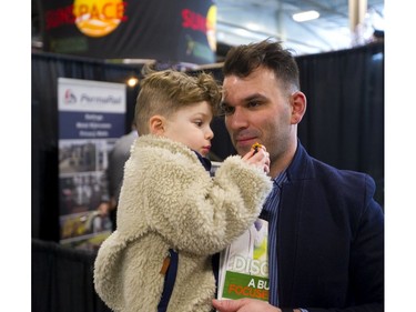 While his dad Kyle and mom Taylor (not shown) were more interested in the displays at the Lifestyle Homeshow at the Western Fair Agriplex Friday, Boyd Hills, 2, turned his attention to his toy bike.  The Hills are building a home near Blue Point on Lake Huron and say they are looking at "everything," at the show.(Mike Hensen/The London Free Press)