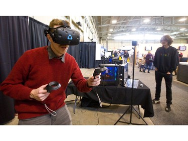 Jester Lind of Ctrl V in London uses an HTC Vive virtual reality gaming system to see worlds not available in "meat space," as Lind refers to reality. Lind's display at the Lifestyle Homeshow at the Western Fair Agriplex  in London, Friday. uses computing power not easily reproduced at home says  Lind, who recommends commercial sites like his own to get a real VR impact. (Mike Hensen/The London Free Press)