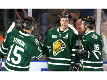 Liam Foudy of the Knights is congratulated by Coe Tymkin and Kevin Hancock after he opened the scoring Friday night with a tip past Windsor's Kari Piiroinen during the first period of their OHL game at Budweiser Gardens. The Knights won 7-0.  (MIKE HENSEN, The London Free Press)