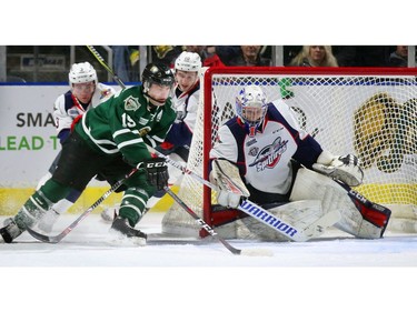 Cole Tymkin of the Knights being chased by Grayson Ladd and Jordan Frasca of the Spitfire's goes for a wrap around on Kari Piiroinen and nearly gets it past the left pad, but then teammate Kevin Hancock put in it for a 2-0 lead during their OHL game at Budweiser Gardens on Friday night. The Knights won 7-0.  (MIKE HENSEN, The London Free Press)