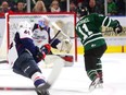 Nathan Staios of the Spitfires is too late to stop Knights forward Connor McMichael from ripping a shot under the glove of Windsor goalie Kari Piiroinen for London’s third goal during the first period of their OHL game at Budweiser Gardens on Friday night. The Knights won 7-0. (MIKE HENSEN, The London Free Press)