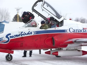 Capt. Robbie Hindle and the legs of a ground crew member create an optical illusion as Hindle exits the CT-114 Tutor jet  flown by Capt. Ari Mahajan to Diamond Aircraft in London. The two made a site visit to London, part of protocol in advance of Airshow London. Afterward, the pilots toured the Fanshawe College school of aviation. (Derek Ruttan/The London Free Press)