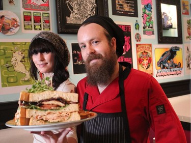 Early Bird co-owner Justin Wolfe and server Jen Chadwick showcase the restaurant's most popular dish, the turducken sandwich. (DALE CARRUTHERS, The London Free Press)