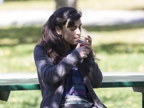 A woman smokes cannabis in a Toronto park on first day of legalization of cannabis across Canada on October 17, 2018. An annual survey by the Centre for Addiction and Mental Health shows cannabis use steadily rose in the years prior to legalization last October.
