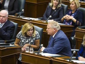 Ontario Minister of Health Christine Elliott and Premier Doug Ford in the Queen's Park legislature. (Postmedia file photo)