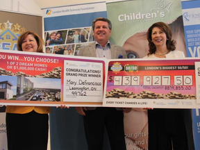 Michelle Campbell, president and CEO of the St. Joseph's Healthcare Foundation, left; John MacFarlane, president and CEO of the London Health Sciences Foundation; and Elana Johnson, Children's Health Foundation's board vice-chair hold two cheques with the names of the top winners for the fall draw of the Dream Lottery in London. JONATHAN JUHA/THE LONDON FREE PRESS