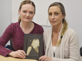 Stephanie Nethery, left, and Tracy MacDonald hold a photo of sister and friend Jessica Nethery who was murdered in 2002. Less than two decades later her killer is up for full parole, and the family says they feel betrayed by Canada's justice system. (Louis Pin/The Observer)