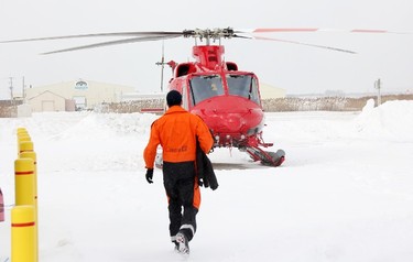 Canadian Coast Guard icebreakers rely on helicopters to see the extent of ice cover in the St. Clair River. Flight engineer Ryan Davis walks towards one of the Bell 412 EPI helicopters in the Coast Guard's fleet at Sarnia Chris Hadfield Airport Tuesday. Tyler Kula/Sarnia Observer/Postmedia Network