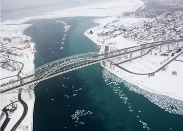 Canadian Coast Guard icebreakers rely on helicopters to see the extent of ice cover in the St. Clair River. The water under the Blue Water Bridge was mostly ice-free Tuesday. Tyler Kula/Sarnia Observer/Postmedia Network
