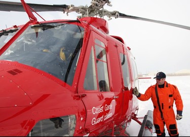 Canadian Coast Guard icebreakers rely on helicopters to see the extent of ice cover in the St. Clair River. Pilot Mark Pearson goes over safety information before takeoff from the Sarnia Chris Hadfield Airport Tuesday. Tyler Kula/Sarnia Observer/Postmedia Network