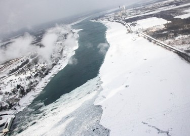 Canadian Coast Guard icebreakers rely on helicopters to see the extent of ice cover in the St. Clair River. The ice begins to thicken Tuesday just to the south of the defunct Lambton Generating Station site. Tyler Kula/Sarnia Observer/Postmedia Network