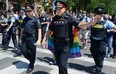 Former London Police Chief John Pare, centre, marchs with his officers during the annual Gay Pride Parade on Queen's Avenue in 2017. Because police uniforms, cruisers and guns can be triggering for many in the LGBTQ community, they are banned, again, from this year's parade. Police officers still will march in the parade in plain clothes.  (File photo)