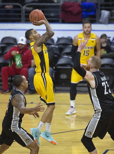 The London Lightning's Xavier Moon shoots of over Nick Evans of the Moncton Magic during their NBL game in London on Thursday. (Derek Ruttan/The London Free Press)