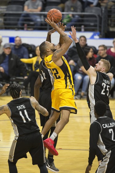 The London Lightning's Marvell Waithe gets a shot off despite being surrounded by four Moncton Magic players during their NBL game against in London on Thursday. (Derek Ruttan/The London Free Press)