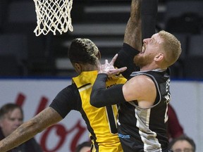 Nick Evans of the Moncton Magic shoots over the London Lightning's Mo Bolden during their NBL game in London Thursday. (Derek Ruttan/The London Free Press)