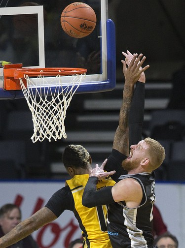 Nick Evans of the Moncton Magic shoots over the London Lightning's Mo Bolden during their NBL game in London Thursday. (Derek Ruttan/The London Free Press)