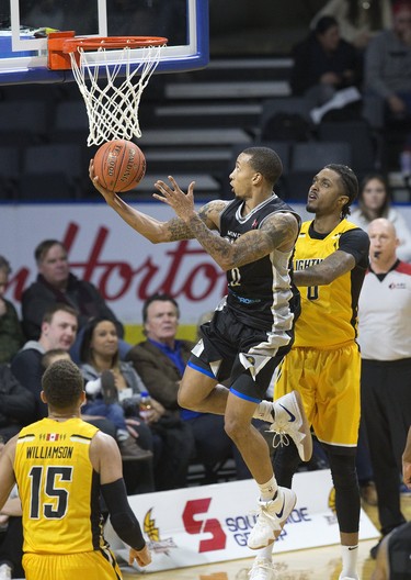 Gentrey Thomas of the Moncton Magic lays up in front of the London Lightning's Mo Bolden during their NBL game in London on Thursday. (Derek Ruttan/The London Free Press)