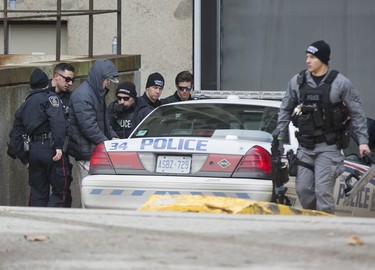 Although surrounded by by several police officers, a man held them at bay by holding a large hunting knife to his neck on Wellington St. just north of Queens Ave in London, Ont. on Sunday January 6, 2019. After and hour-and-a-half of police were able to convince the man to to surrender. Derek Ruttan/The London Free Press/Postmedia Network