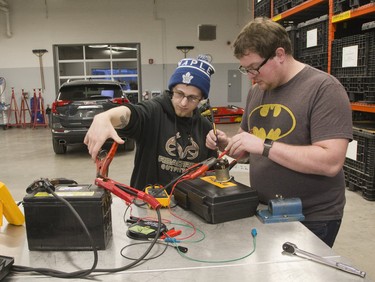 Evan Watson (left) and Kris Roy test the resistance of a solenoid  at Fanshawe College in London, Ont. on Tuesday January 8, 2019.  They are in the General Motors Automotive Service Educational Program . Derek Ruttan/The London Free Press/Postmedia Network