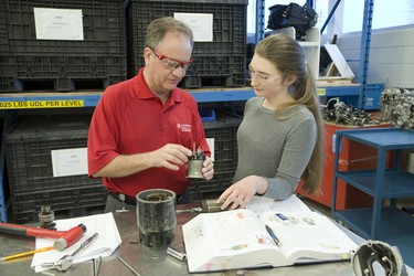 Hans Reimer, coordinator of auto program at Fanshawe College, teaches Rae Heisler in the General Motors Automotive Service Educational Program in London, Ont. on Tuesday January 8, 2019. Derek Ruttan/The London Free Press/Postmedia Network