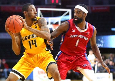 Marcus Capers of the Lightning looks to pass around Bruce Massey of the Cape Breton Highlanders in the first half of their NBL game at Budweiser Gardens in London, Ont.  Photograph taken on Thursday January 10, 2019.  Mike Hensen/The London Free Press/Postmedia Network