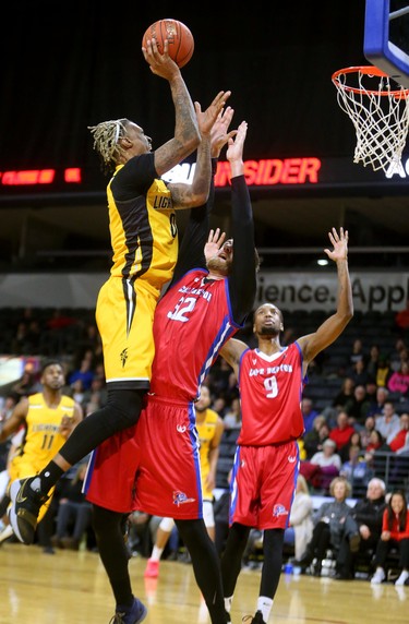 Maurice Bolden of the Lightning adds some vertical jump to his 6'10" height as he shoots over Tanner Giddings of the Cape Breton Highlanders in the first half of their NBL game at Budweiser Gardens in London, Ont.  Photograph taken on Thursday January 10, 2019.  Mike Hensen/The London Free Press/Postmedia Network